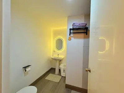 a small bathroom with a toilet and a sink at The Cube in Cubao in Quezon City