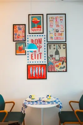a table in a room with pictures on the wall at The Cube in Cubao in Quezon City