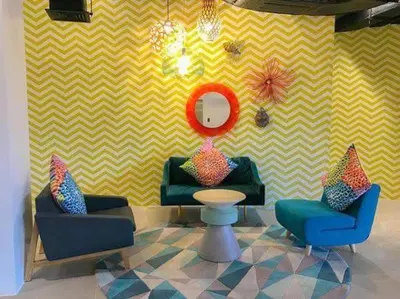 a room with two chairs and a table and a mirror at Aveline Suites Riverline in Manila