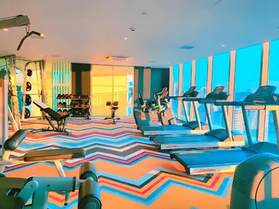 a gym with several treadmills and pilates equipment at Aveline Suites Riverline in Manila