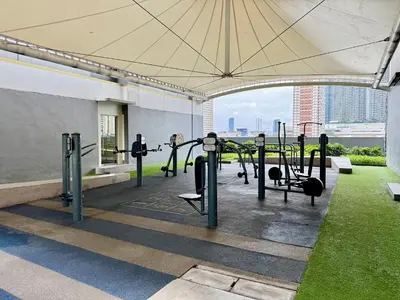 a gym with some equipment in a building at Prime Location condo near MRT, SM Megamall, BGC! in Manila