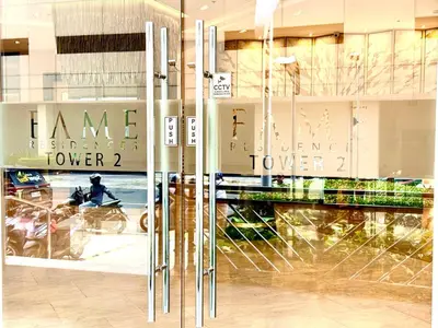 a store front with glass doors and a person on a bike at Prime Location condo near MRT, SM Megamall, BGC! in Manila