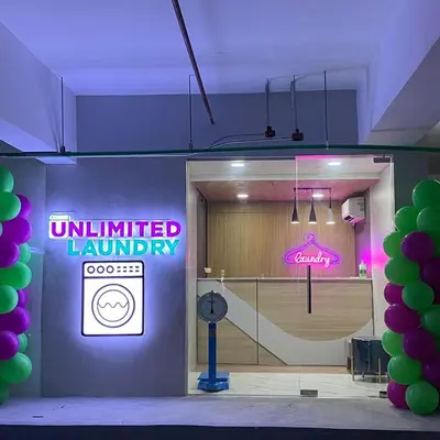 an entrance to a gym with an unlimited laundry sign at Prime Location condo near MRT, SM Megamall, BGC! in Manila