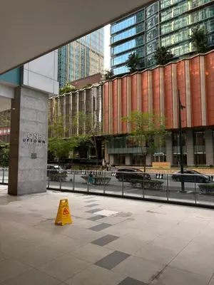 a yellow cone on a sidewalk in front of a building at ONE UPTOWN RESIDENCE BGC 2-bed 1BR in Manila
