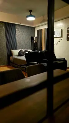 a living room with a couch and a bed at SW Staycation Liam Suite SMDC Hope Residences Beside SM City in Trece Martires