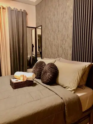 a bed with two balls of yarn and a mirror at SW Staycation Liam Suite SMDC Hope Residences Beside SM City in Trece Martires