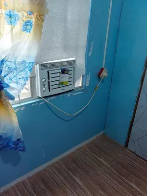 a room with a air conditioner next to a window at Harong ni Lynda in Ibaba