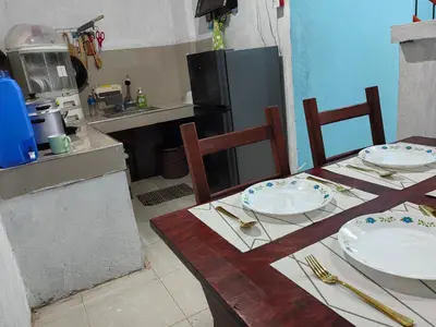 a kitchen with a table with plates on it at Harong ni Lynda in Ibaba