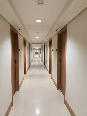 an empty hallway in a building with wooden doors at Mall of Asia shore 3 tower 2 residence in Manila