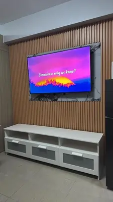 a flat screen tv on a wall in a room at Cozy home in Manila