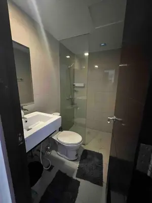 a bathroom with a toilet and a sink and a shower at Studio Unit McKinleyHill near Venice Grand Canal in Manila