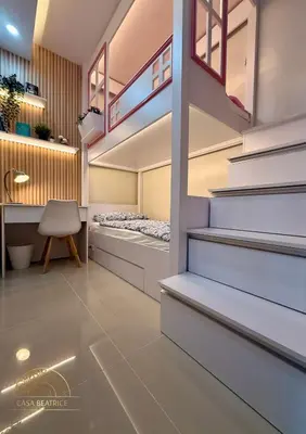 a room with two bunk beds and a desk at 2BR Luxe Staycation in Charm Residences in Manila