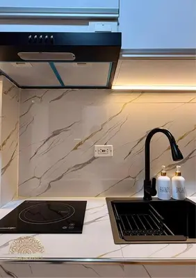 a kitchen counter with a sink and aaucet at 2BR Luxe Staycation in Charm Residences in Manila