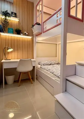 a small room with a bed and a desk at 2BR Luxe Staycation in Charm Residences in Manila