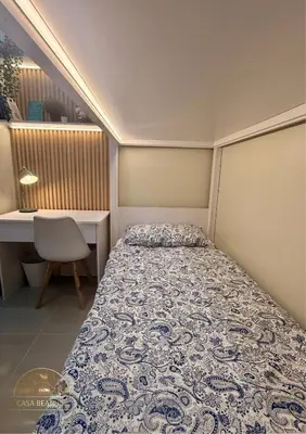 a small bedroom with a bed and a desk at 2BR Luxe Staycation in Charm Residences in Manila