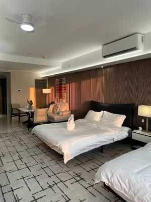 a bedroom with two beds and a living room at Spacious 12-Pax Stay Near Airport, City of Dreams, Okada, Ayala Malls, MOA & Solaire in Manila