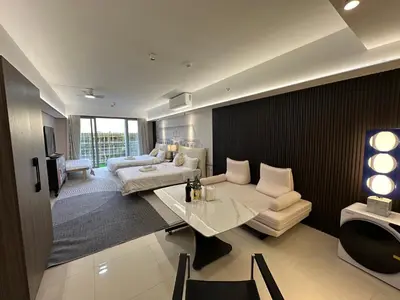 a bedroom with a bed and a table and a couch at Spacious 12-Pax Stay Near Airport, City of Dreams, Okada, Ayala Malls, MOA & Solaire in Manila