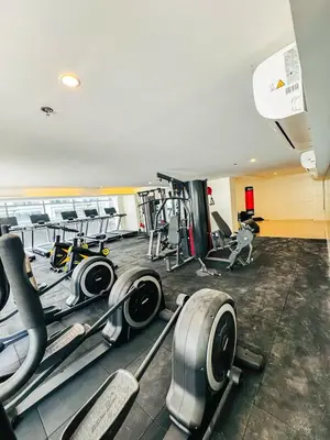 a gym with several treadmills and exercise machines at Spacious 12-Pax Stay Near Airport, City of Dreams, Okada, Ayala Malls, MOA & Solaire in Manila