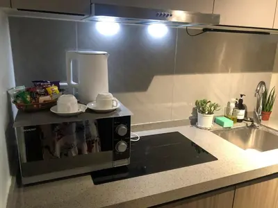 a microwave on a counter in a kitchen at Spacious 12-Pax Stay Near Airport, City of Dreams, Okada, Ayala Malls, MOA & Solaire in Manila