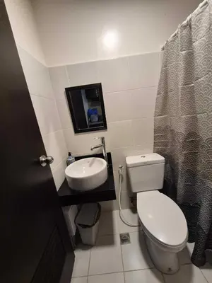 a small bathroom with a toilet and a sink at B&C studio in Manila