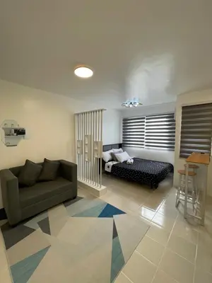 a living room with a couch and a bed at Stylish Minimalist Comfort Stay Beside EK in Santa Rosa