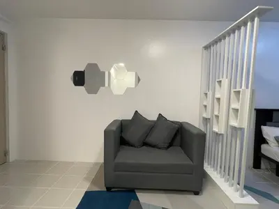 a living room with a couch and a staircase at Stylish Minimalist Comfort Stay Beside EK in Santa Rosa