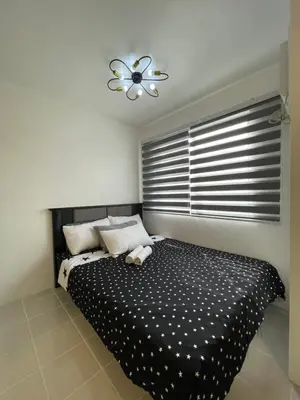 a bedroom with a black and white bed with a window at Stylish Minimalist Comfort Stay Beside EK in Santa Rosa