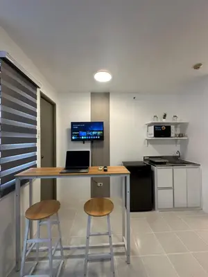 a kitchen with a desk with a laptop and two stools at Stylish Minimalist Comfort Stay Beside EK in Santa Rosa