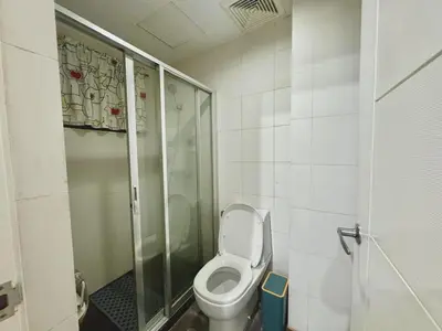 a bathroom with a toilet and a shower at KL Studio close to Greenbelt in Manila