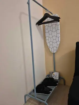 a metal shelf with shoes in a room at B&C Studio Kasara Urban Resort Residences in Manila