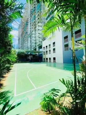 a tennis court in front of a building at B&C Studio Kasara Urban Resort Residences in Manila