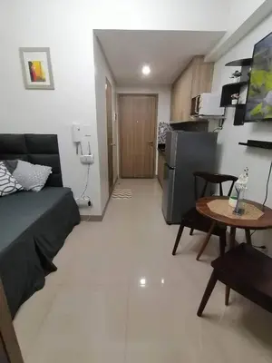 a living room with a couch and a table at The Donegal with WI-FI Netflix Parking with fee in Manila