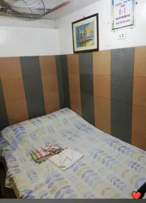 a small bed in a room with a bedspread on it at Edison Lodge hotel in Manila