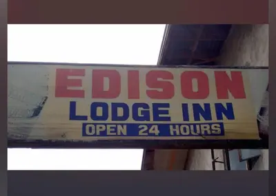 a sign that says electron lodge inn open hours at Edison Lodge hotel in Manila