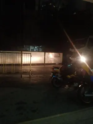 a motorcycle parked in a parking lot at night at Edison Lodge hotel in Manila