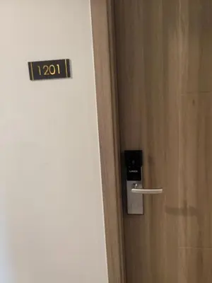 a door with a thermometer on it next to a door at AHD Staycation in Manila