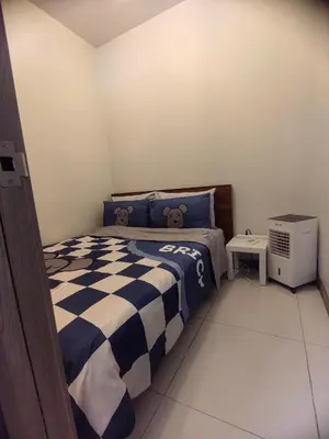 a bedroom with a bed with a teddy bear on it at AHD Staycation in Manila