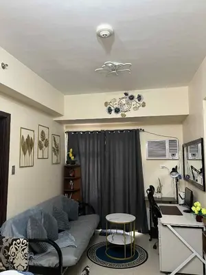 a living room with a couch and a table at Luxury 1BR BayFront Staycation - Free Wi-Fi, Swimming POOL, Near Airport, MOA and PICC in Manila