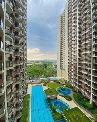 an aerial view of two tall buildings and a swimming pool at Luxury 1BR BayFront Staycation - Free Wi-Fi, Swimming POOL, Near Airport, MOA and PICC in Manila