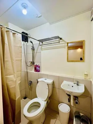 a bathroom with a toilet and a sink at 1Haven in Pasig CCF Bridgetown in Manila