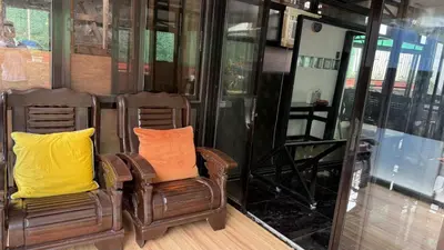 two chairs with orange and yellow pillows in a room at Noirescape in Binangonan
