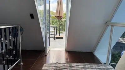 a hallway with a door leading to a balcony at Noirescape in Binangonan