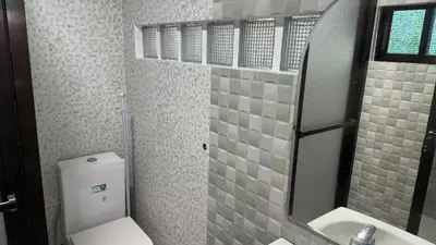 a bathroom with a toilet and a sink and a mirror at Noirescape in Binangonan