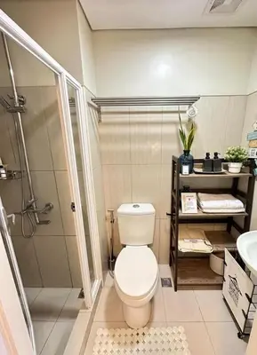 a bathroom with a toilet and a shower at Luxury staycation at prime location Mall of Asia Shell Residences Pasay Tower C in Manila