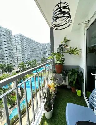 a balcony with a view of a swimming pool at Luxury staycation at prime location Mall of Asia Shell Residences Pasay Tower C in Manila