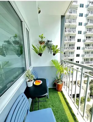 a balcony with a table and plants on it at Luxury staycation at prime location Mall of Asia Shell Residences Pasay Tower C in Manila