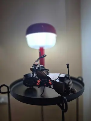 a table with a lamp and a camera on it at B&C Studio Kasara Urban Resort Residences in Manila