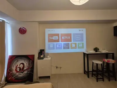 a room with a large screen in the corner of a room at B&C Studio Kasara Urban Resort Residences in Manila