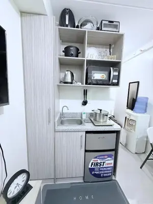 a small kitchen with a sink and a stove at Michaels Cozy Retreat in Cubao in Manila
