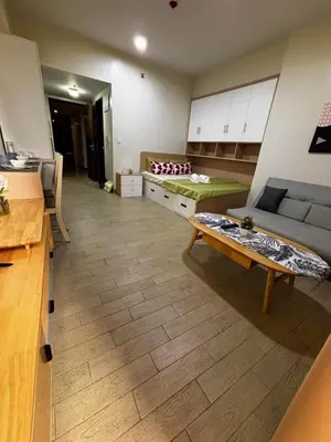 a living room with a couch and a table at DH Suites in Manila